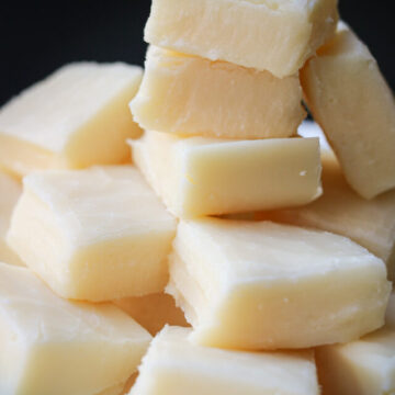 stack of white chocolate fudge with a black background.
