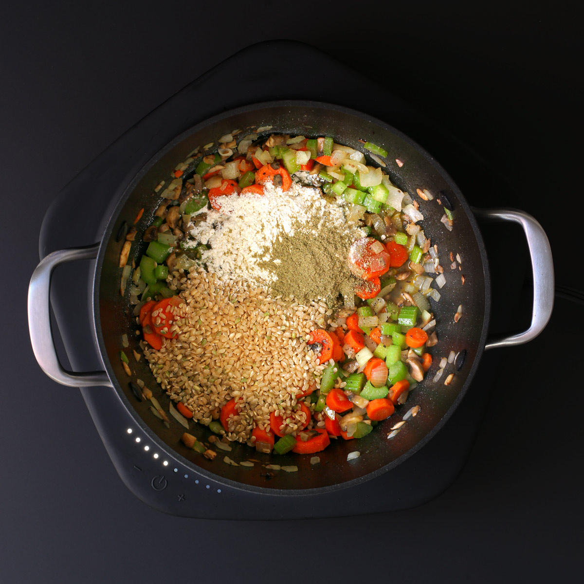 adding flour, rice, and sage to the veggies in the pot.