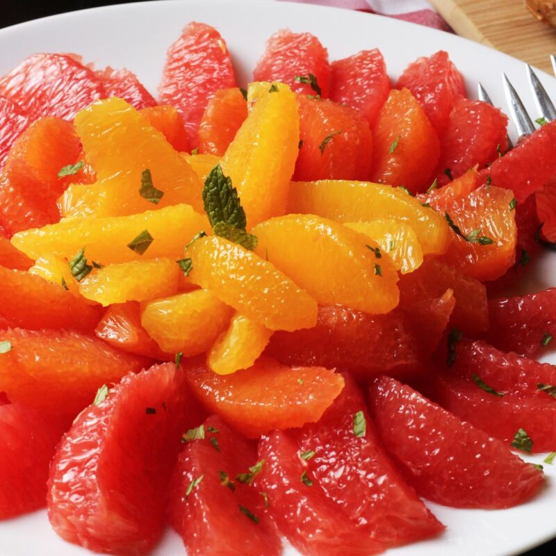 close up of citrus salad on white platter.