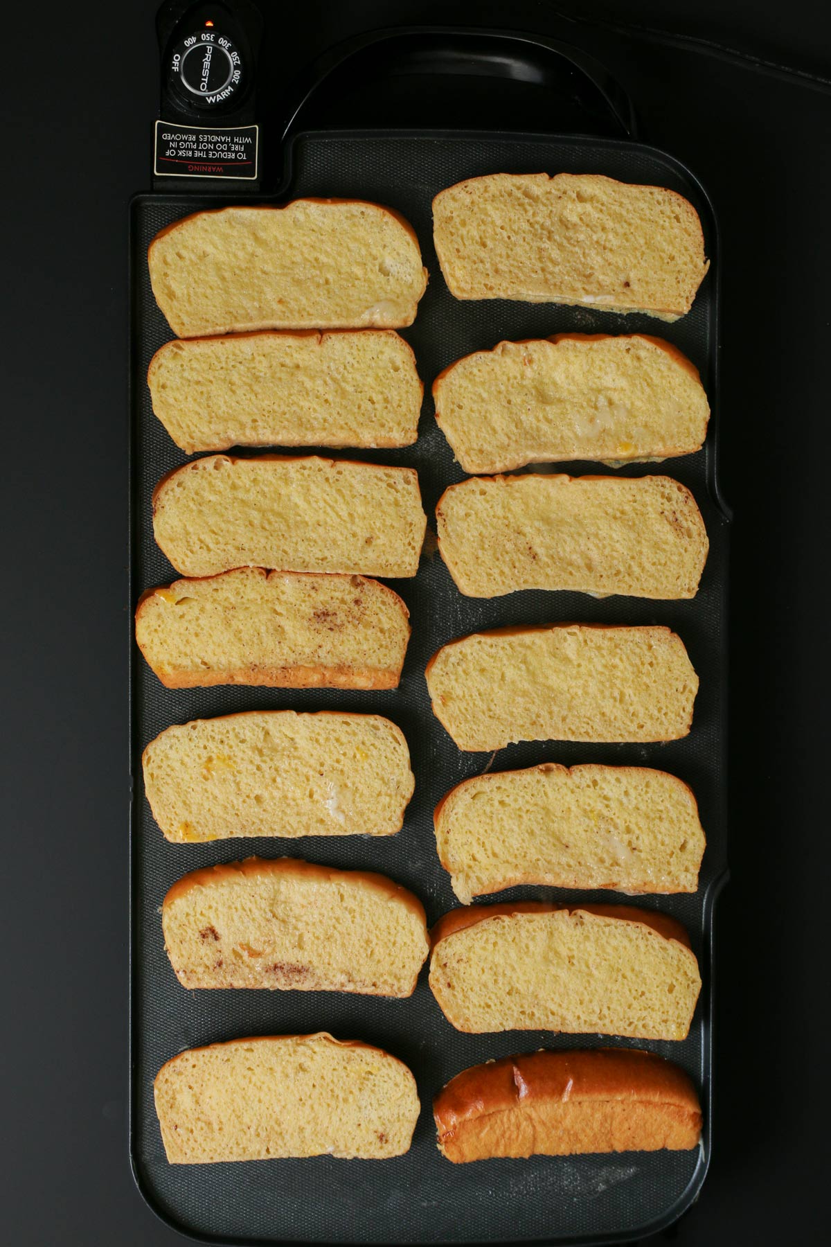 dipped bread slices on large griddle.