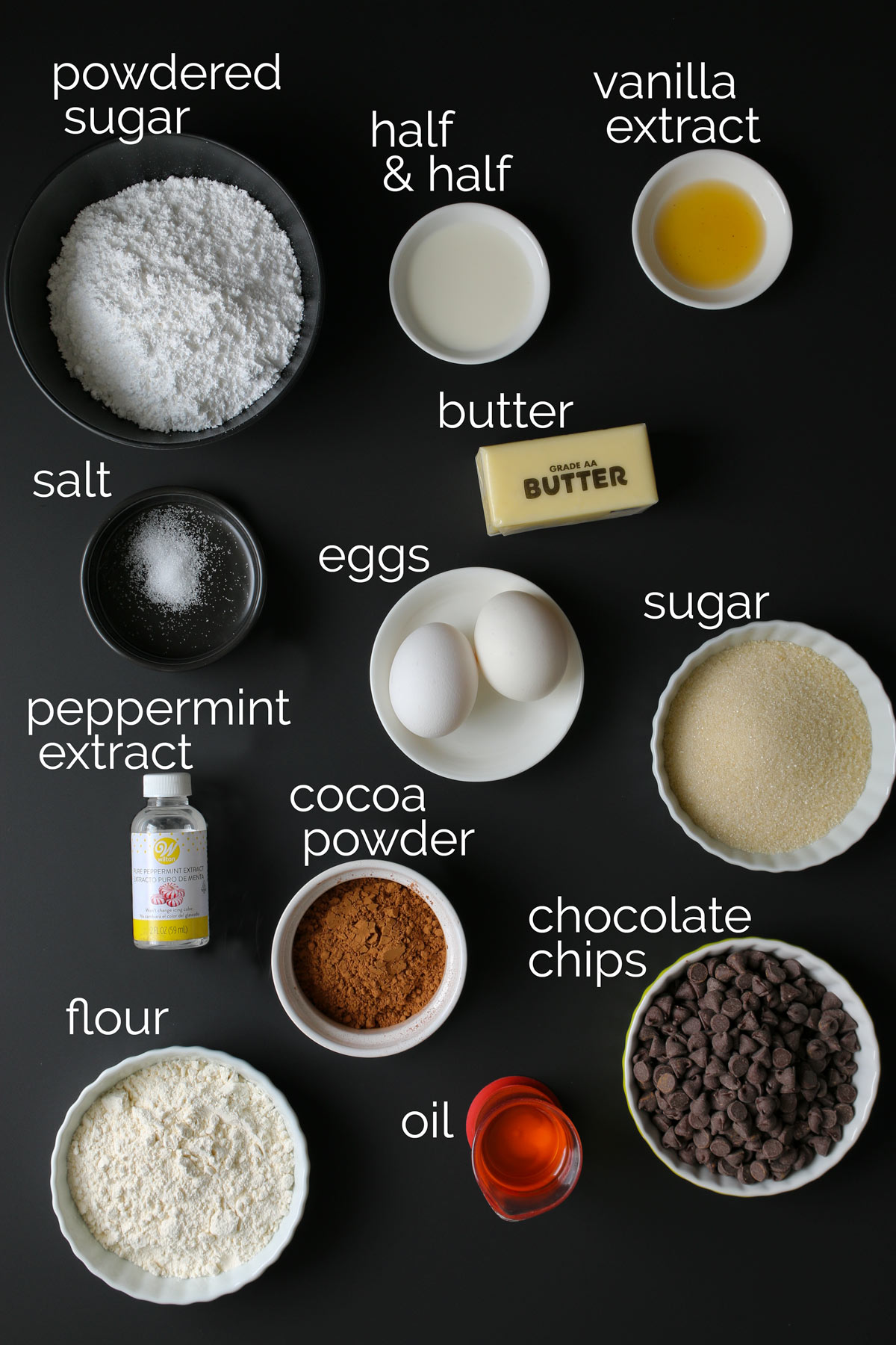 ingredients for chocolate mint brownies on black counter.