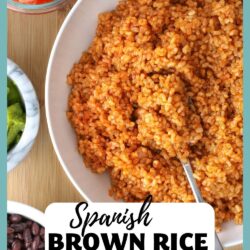 bowl of Spanish brown rice in white bowl with a spoon resting in it, with text overlay.