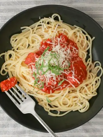 overhead shot of bowl of spaghetti with crock pot sauce.