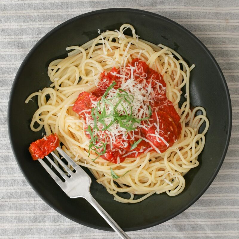 overhead shot of bowl of spaghetti with crock pot sauce.