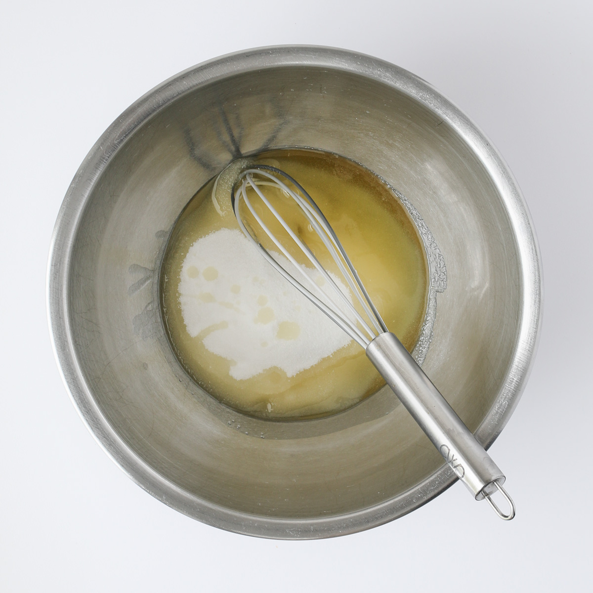 oil and sugar in mixing bowl with a whisk.