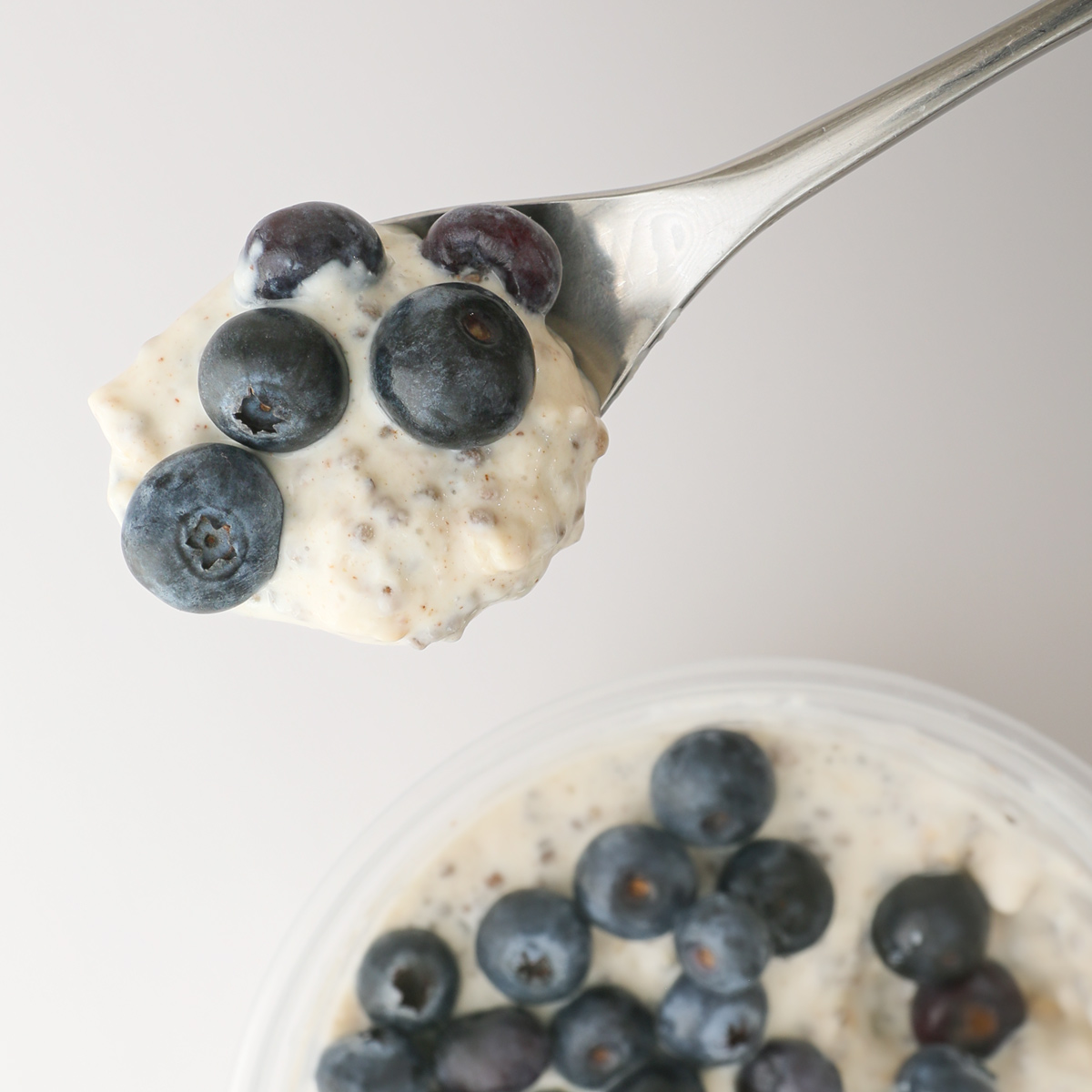 spoonful of protein overnight oats with blueberries.
