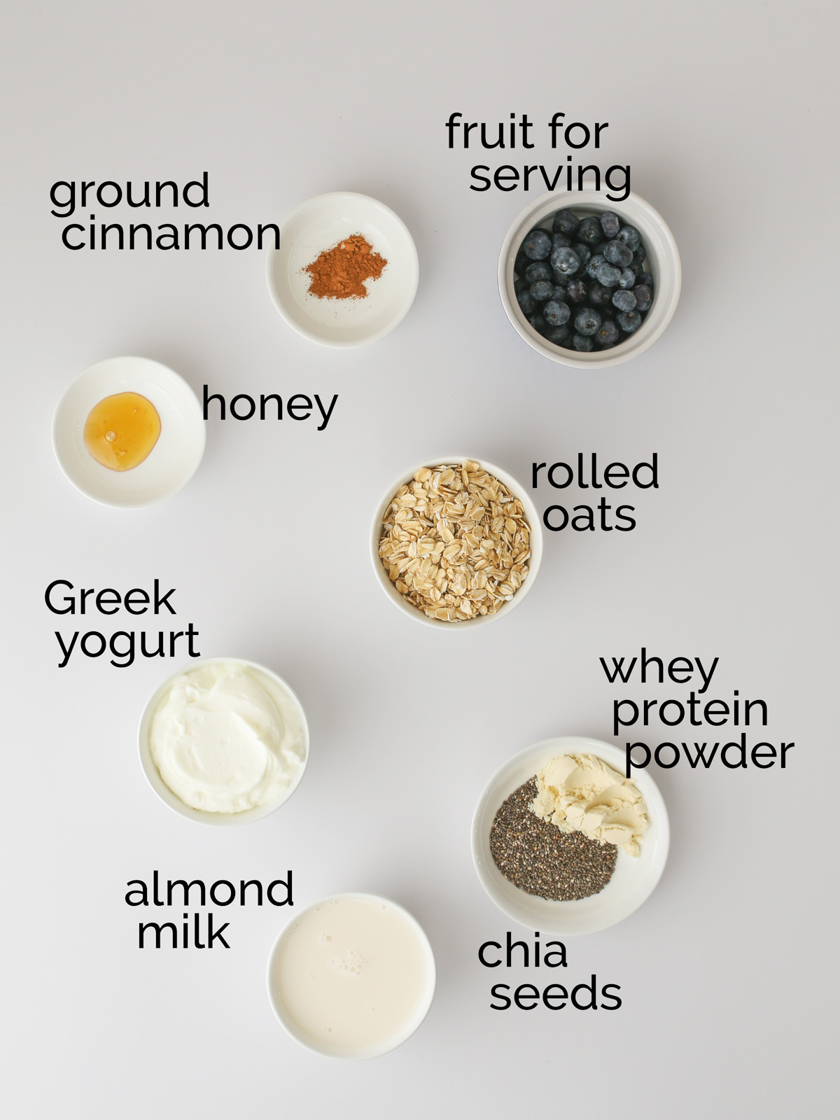 ingredients for protein overnight oats on white counter.