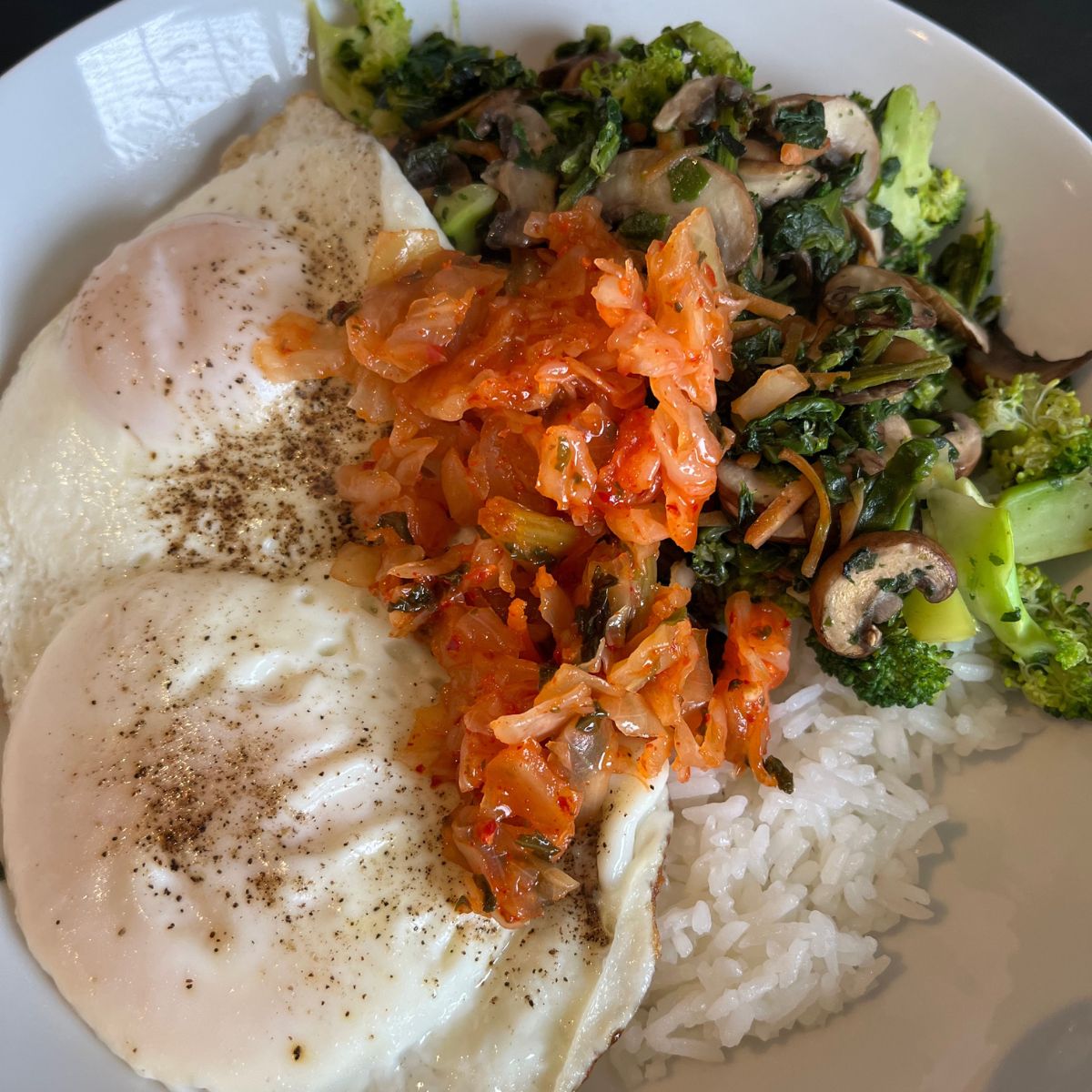 eggs and kimchi with rice and veggies.