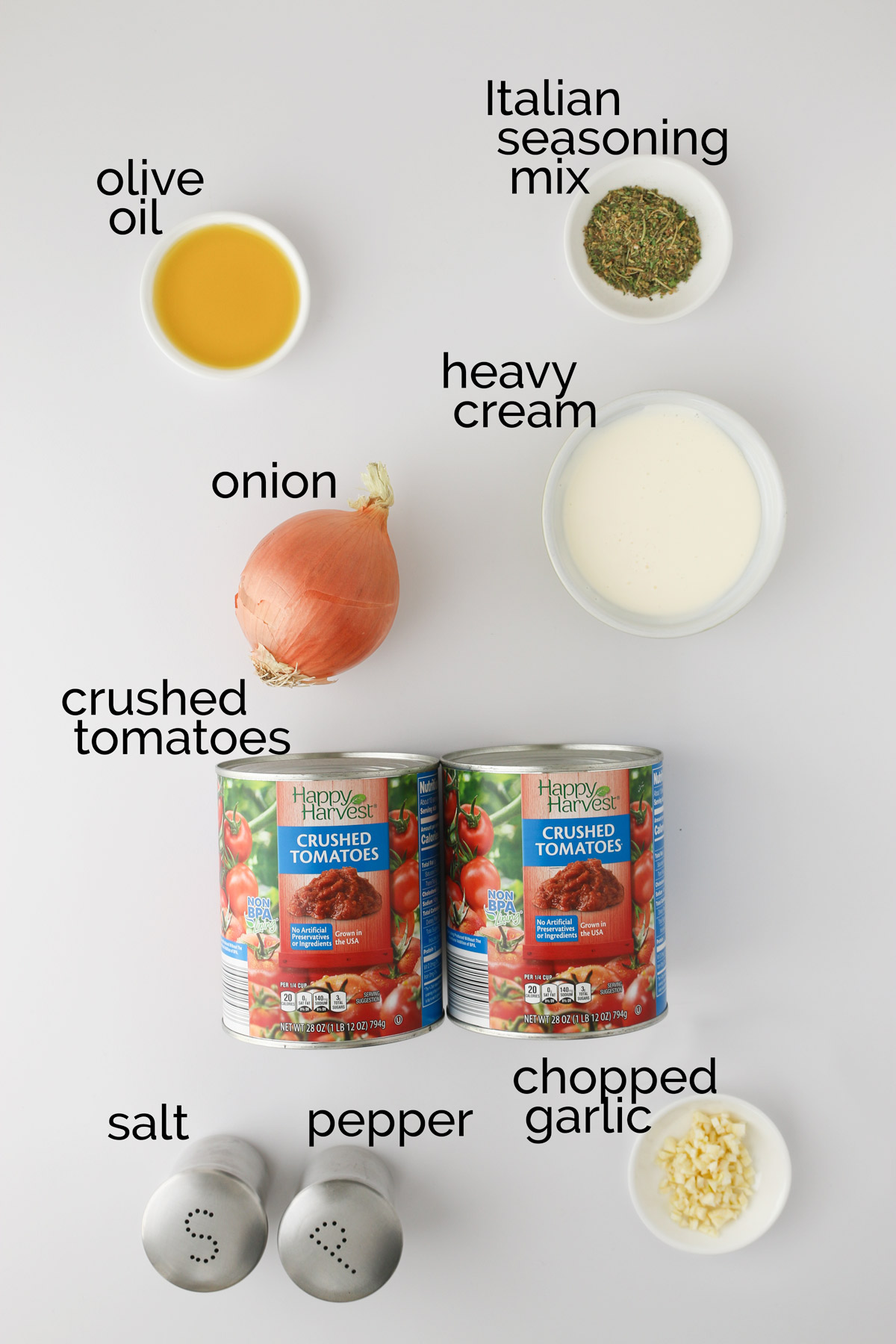 tomato soup ingredients laid out on a white counter.