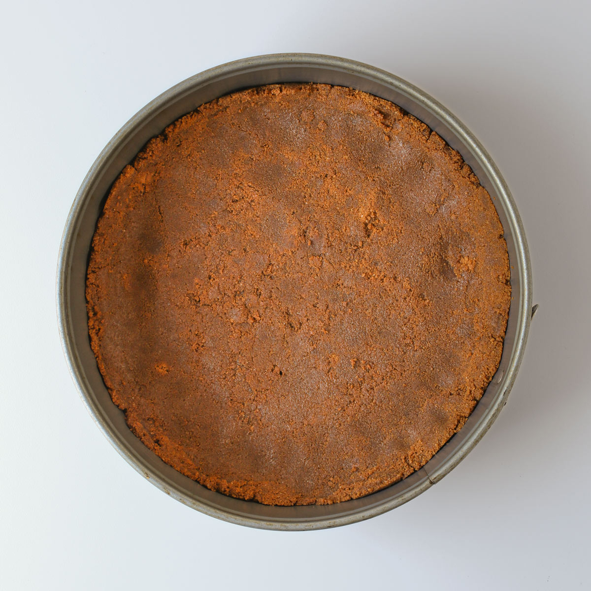 Biscoff mixture pressed into pan for baking.