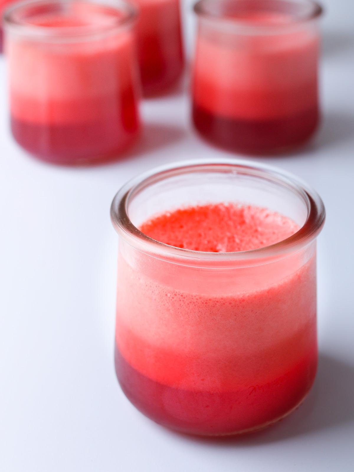 glasses with jello 123 dessert in raspberry flavor on white table.