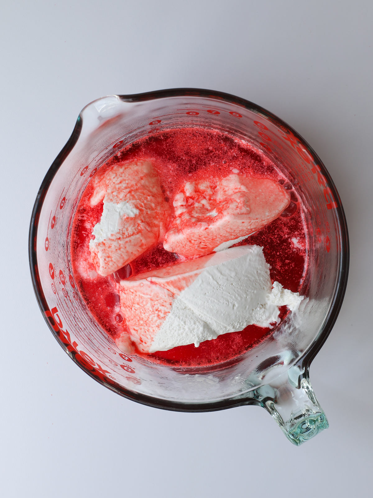 adding frozen whipped topping to hot jello mixture.