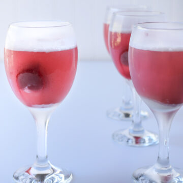 goblets of raspberry sherbet punch on a white table.
