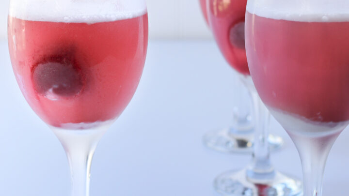 goblets of raspberry sherbet punch on a white table.