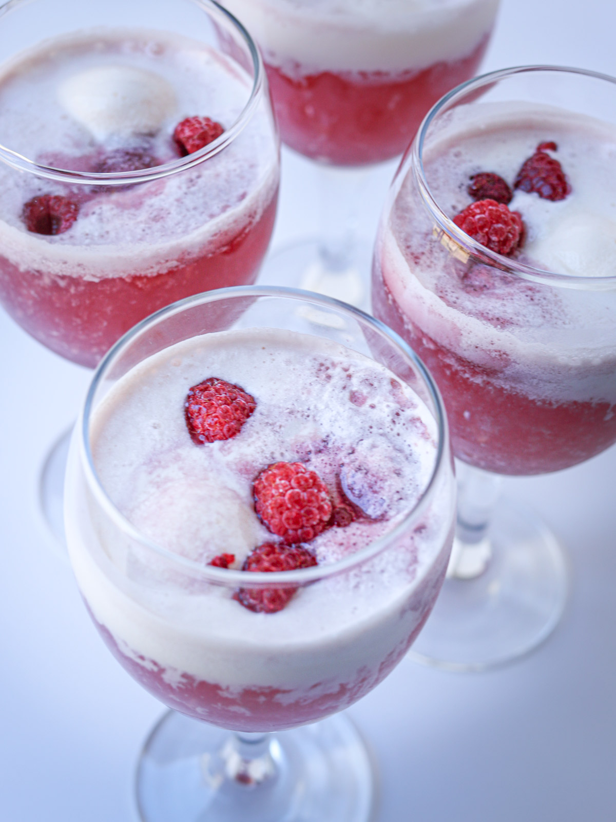 array of goblets with raspberries floating in sherbet punch.