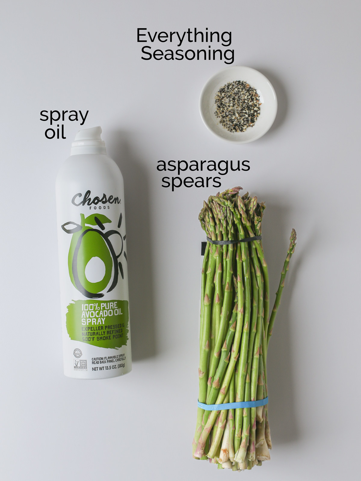 ingredients for making air fryer asparagus laid out on a white counter.