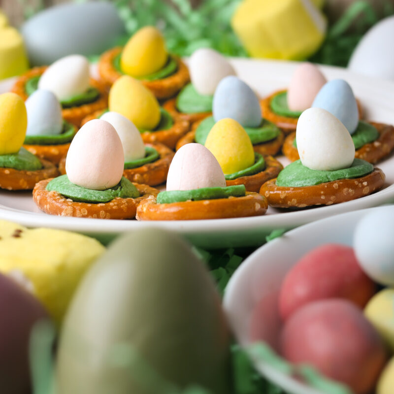 easter pretzels on a tray with other easter candies and Easter eggs.