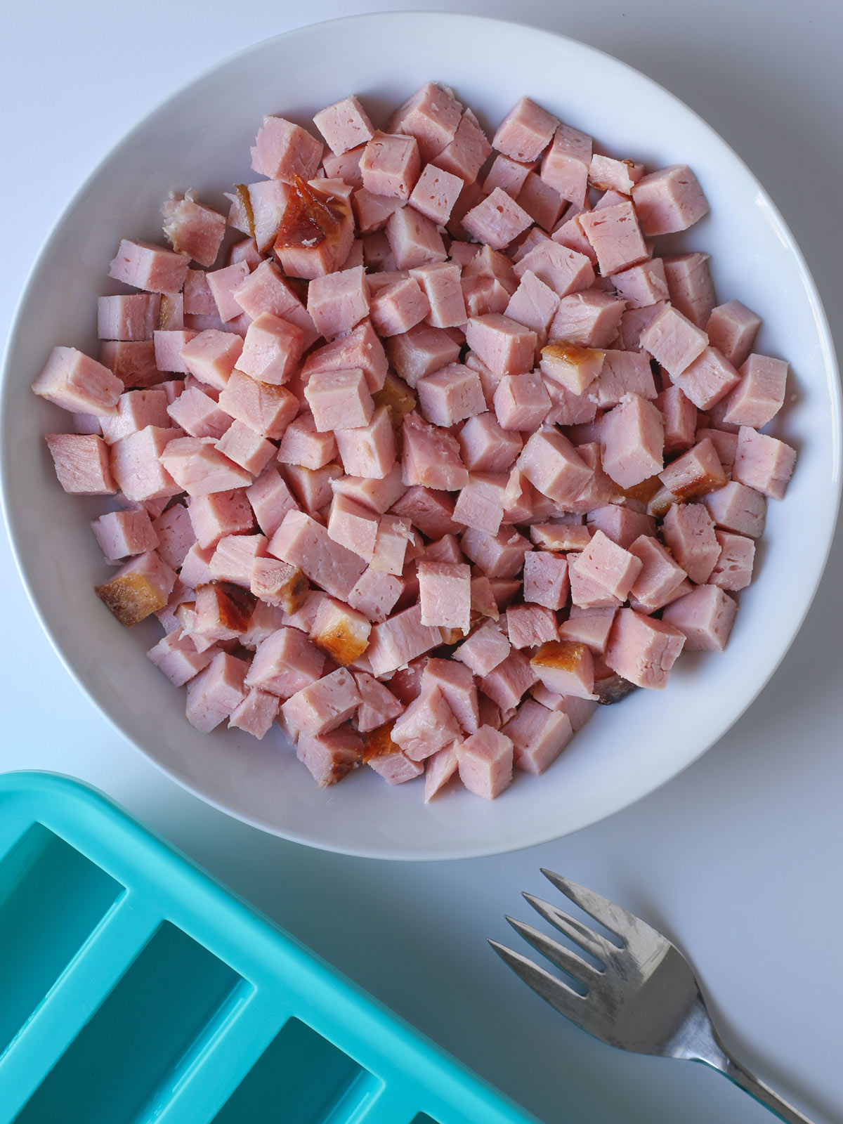 diced ham in a bowl with soupercubes nearby.