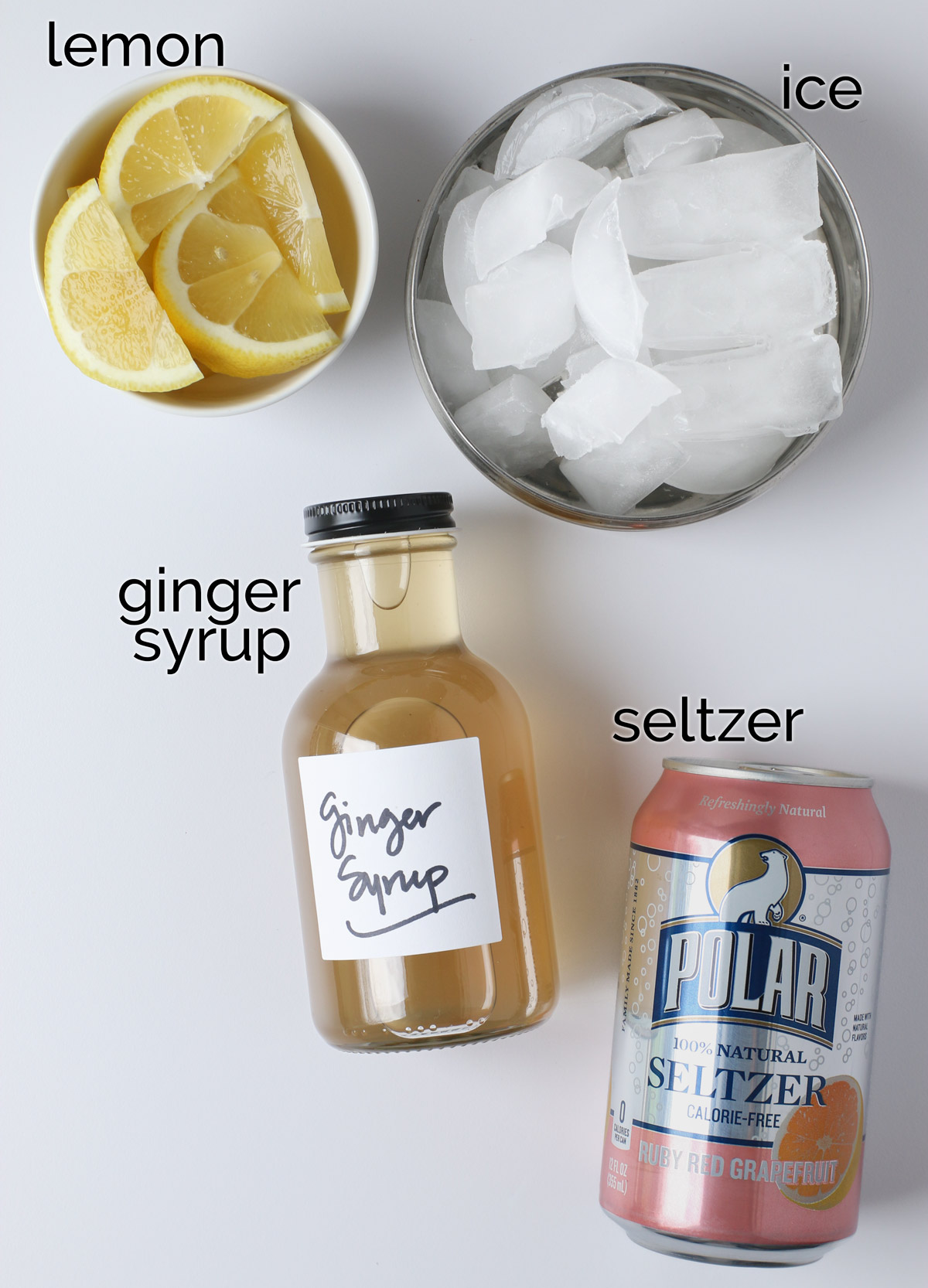 ingredients to make homemade ginger ale on white counter.