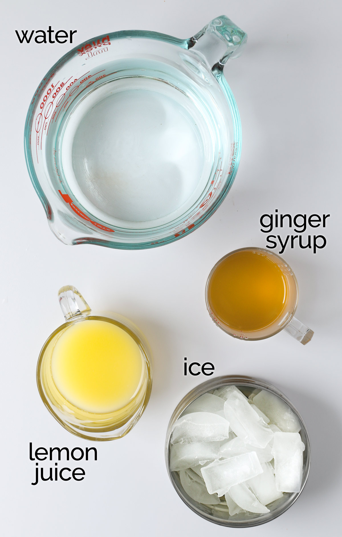 ingredients to make ginger lemonade on white table.