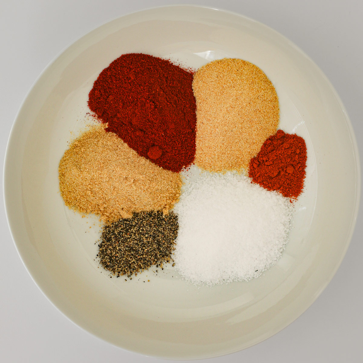 all the spices in a small plate in piles.