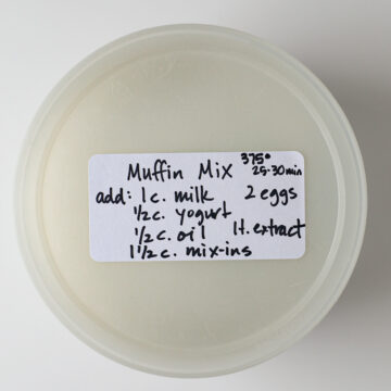 sealed plastic tub full of muffin mix with a label on the top.