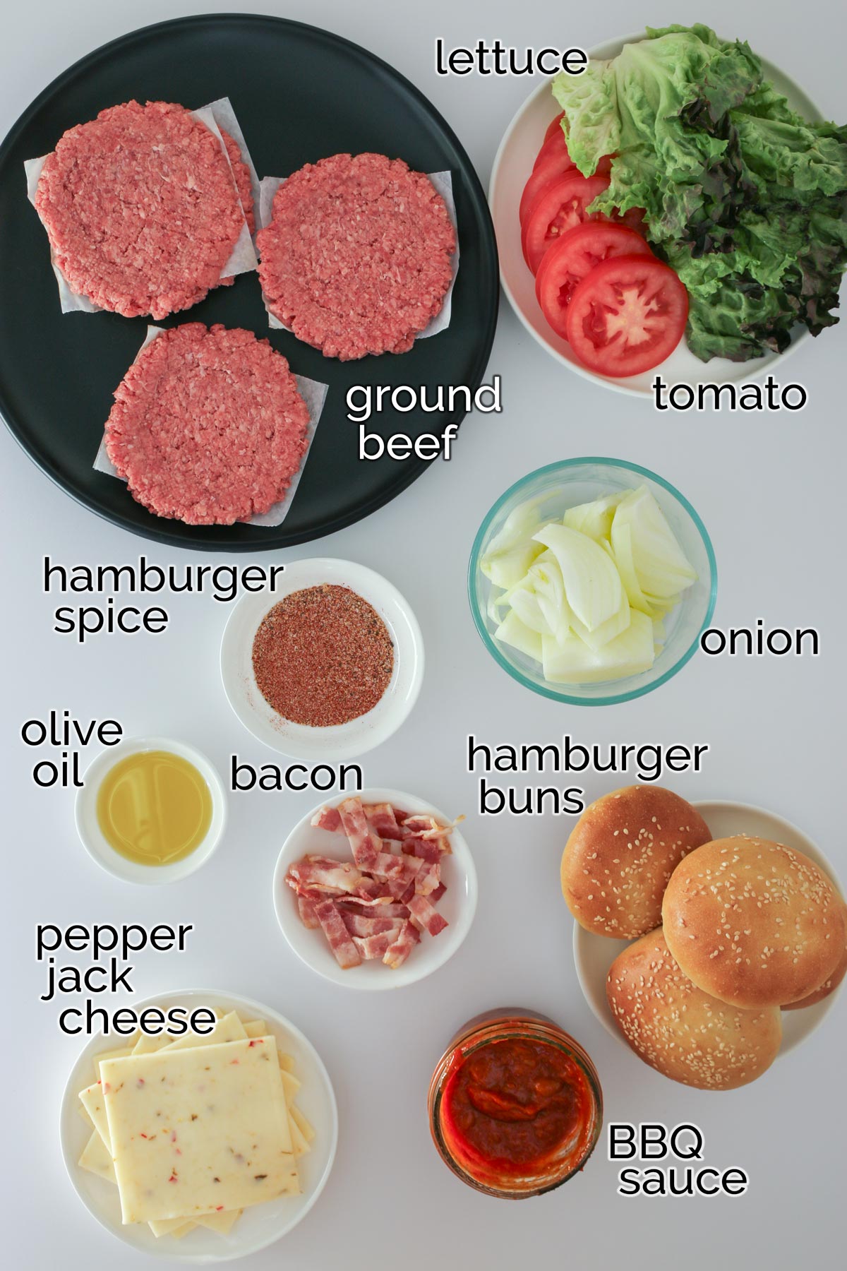 ingredients for bbq bacon burgers, laid out on a white counter.