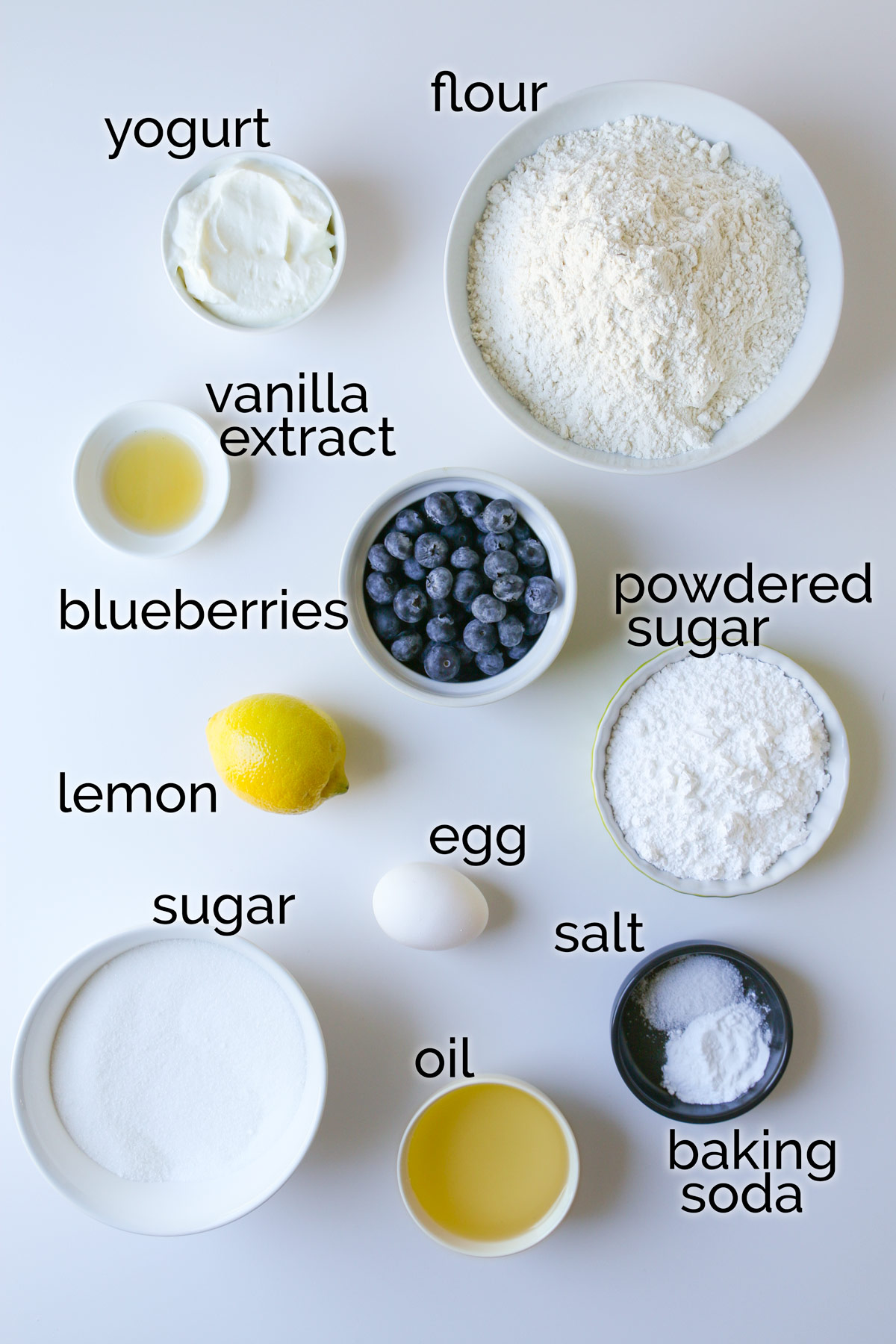ingredients for blueberry cookies laid out on a white counter.