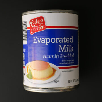 can of evaporated milk on black background.