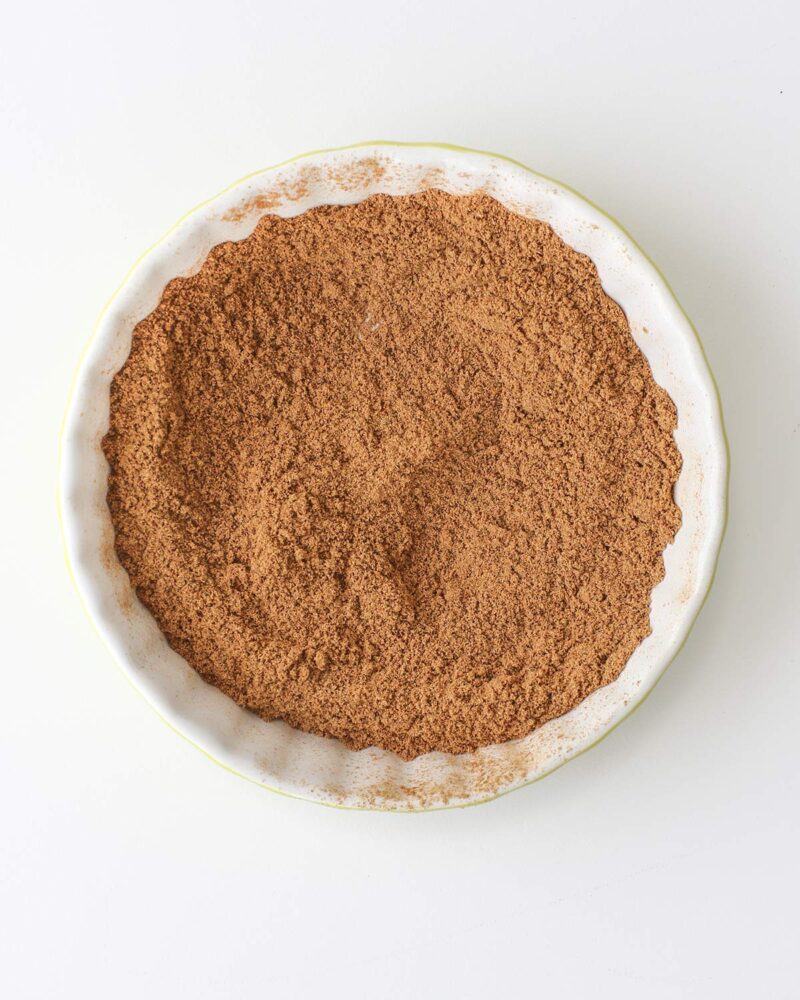 the sifted and mixed pumpkin spice in a white dish.