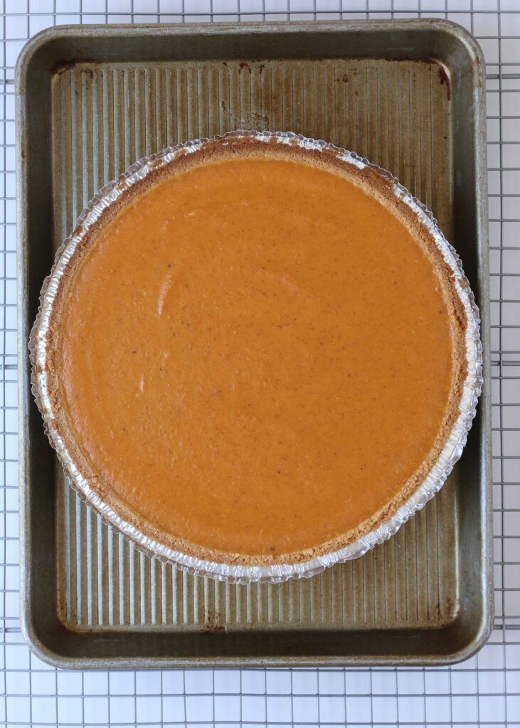 parbaked pumpkin pie on baking sheet.