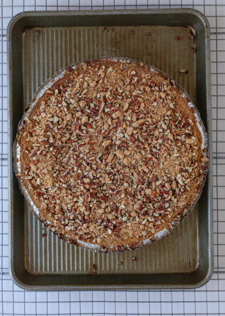 parbaked pie on baking sheet topped with unbaked streusel.
