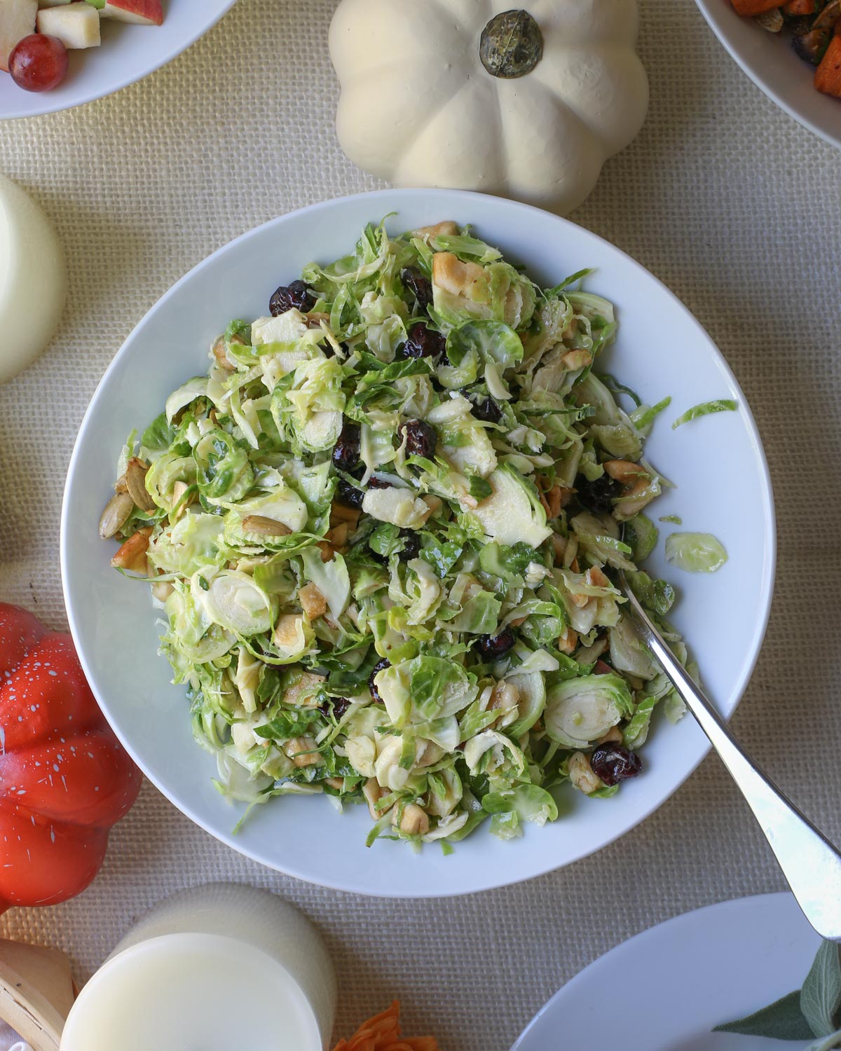 bowl of brussels sprouts salad on a holiday dinner table.