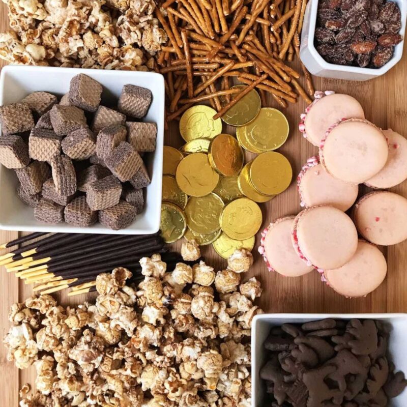 close up of chocolate desserts on a large wooden board.