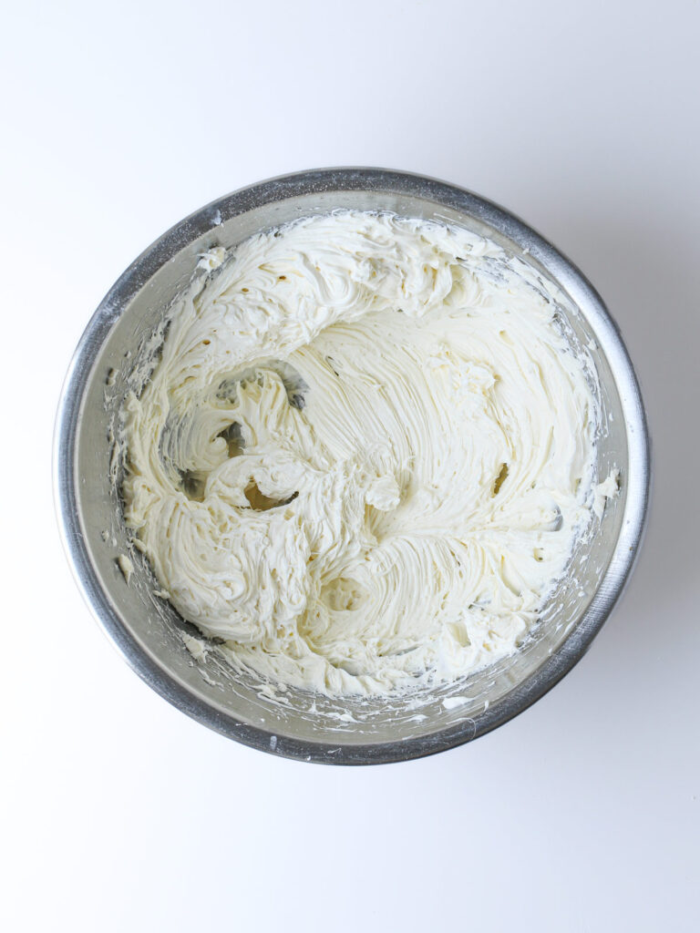 whipped sweet cream cheese in metal bowl.