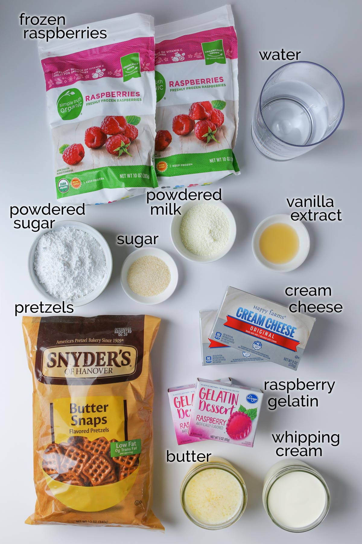 ingredients for raspberry pretzel dessert laid out on a white counter.