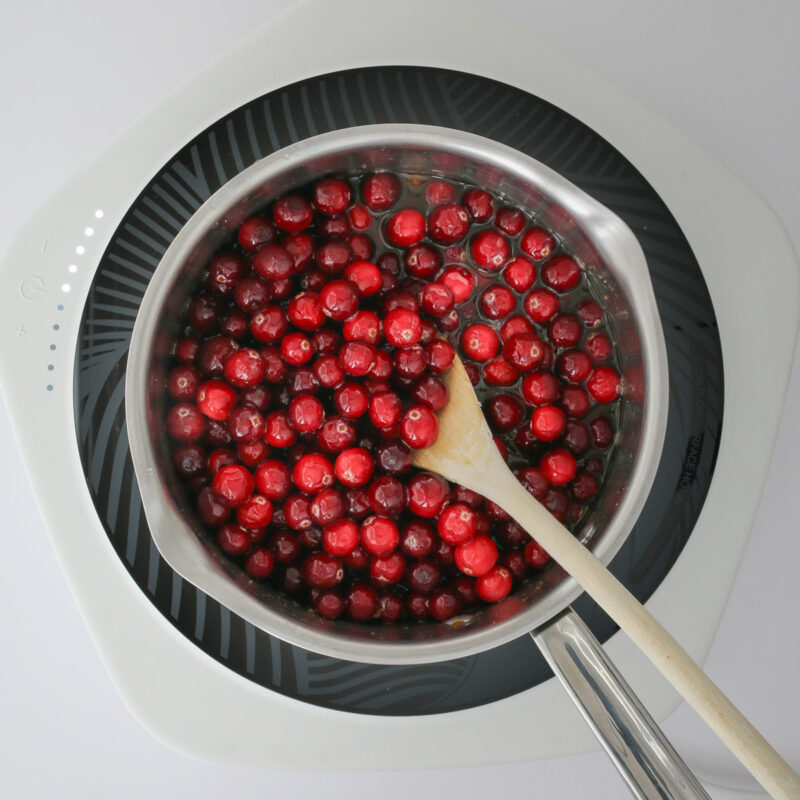 the cranberries starting to cook down in the pan.