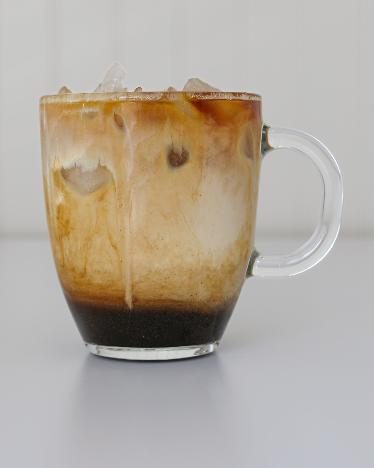 iced gingerbread latte on a white counter with a white background.