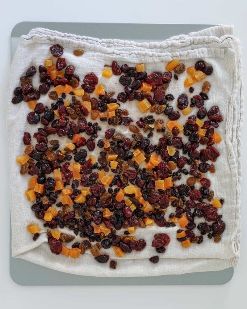 blotting the dried fruit dry on a towel.