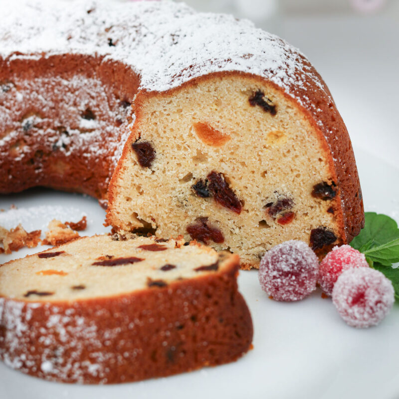 sliced Christmas bundt cake on a white platter.