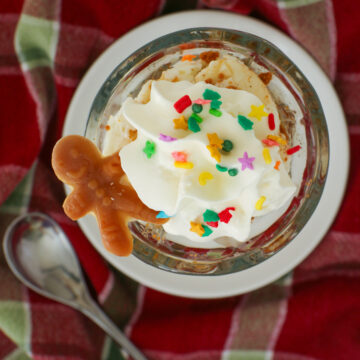 overhead shot of gingerbread sundae atop a plaid napkin with a spoon.
