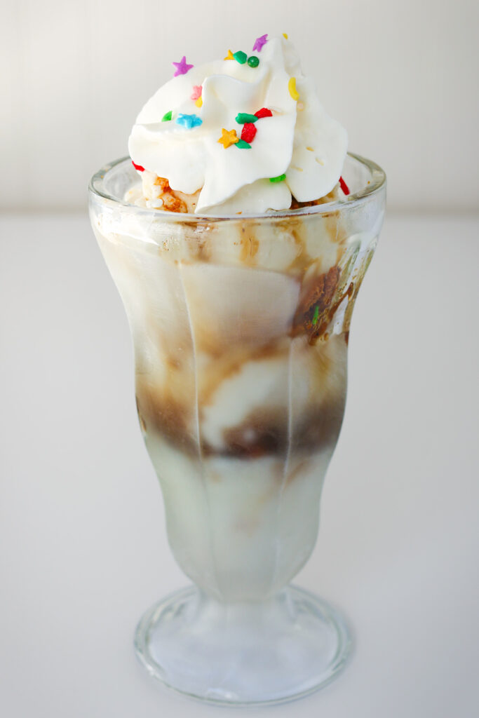 whipped cream and sprinkles on a gingerbread sundae.