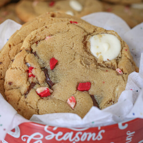 peppermint chocolate chip cookies in a red Christmas tin with white tissue paper.
