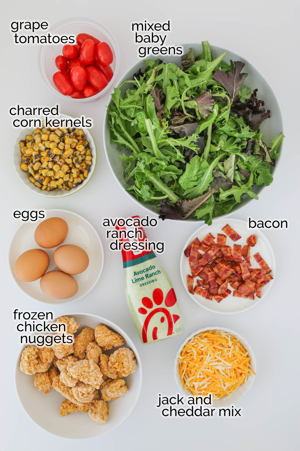 ingredients to make a chick-fil-a cobb salad laid out on a white table.