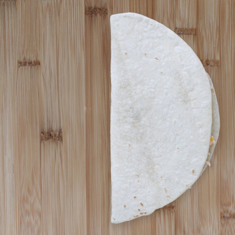 the tortilla folded in half over the filling.