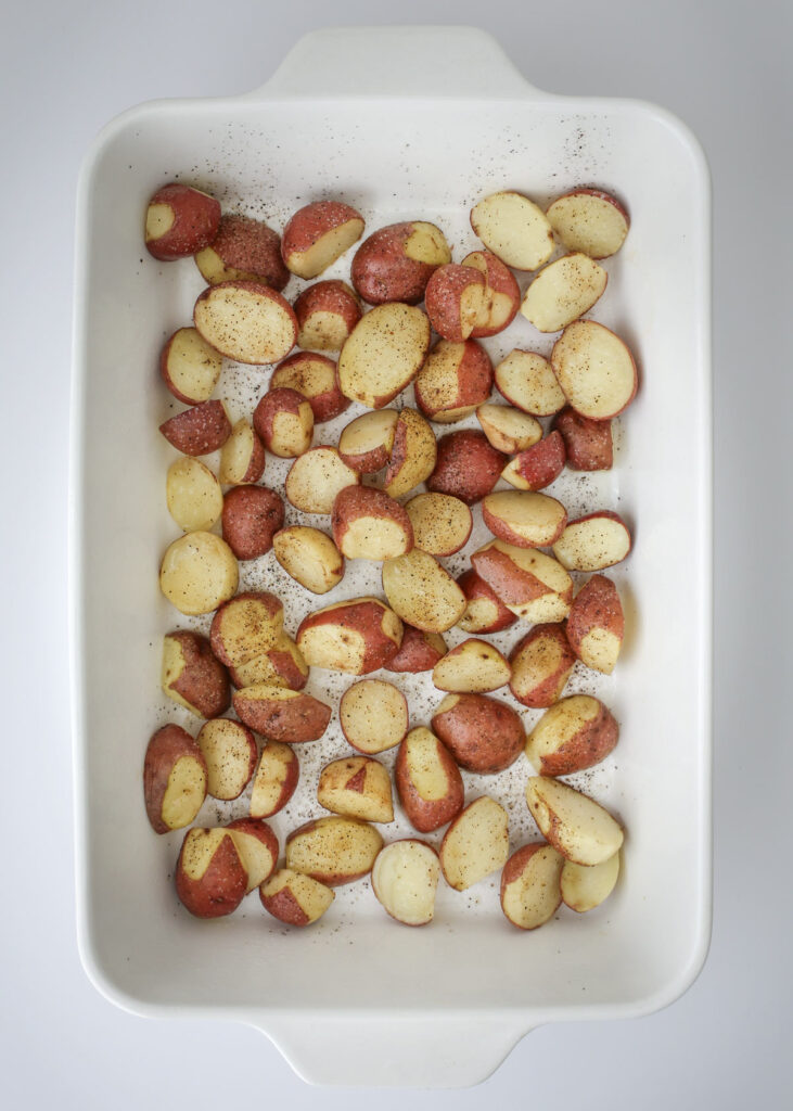 cooked potatoes in the white baking dish.