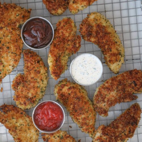chicken strips on wire rack with sauce cups.