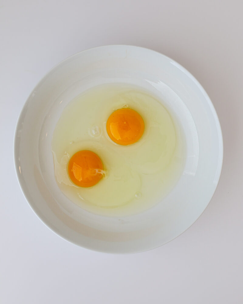 two eggs in a shallow white bowl.