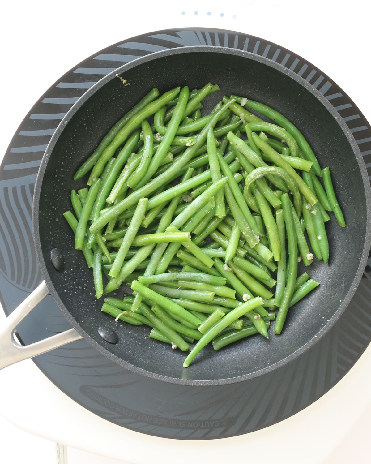 green beans cooked in skillet with garlic.