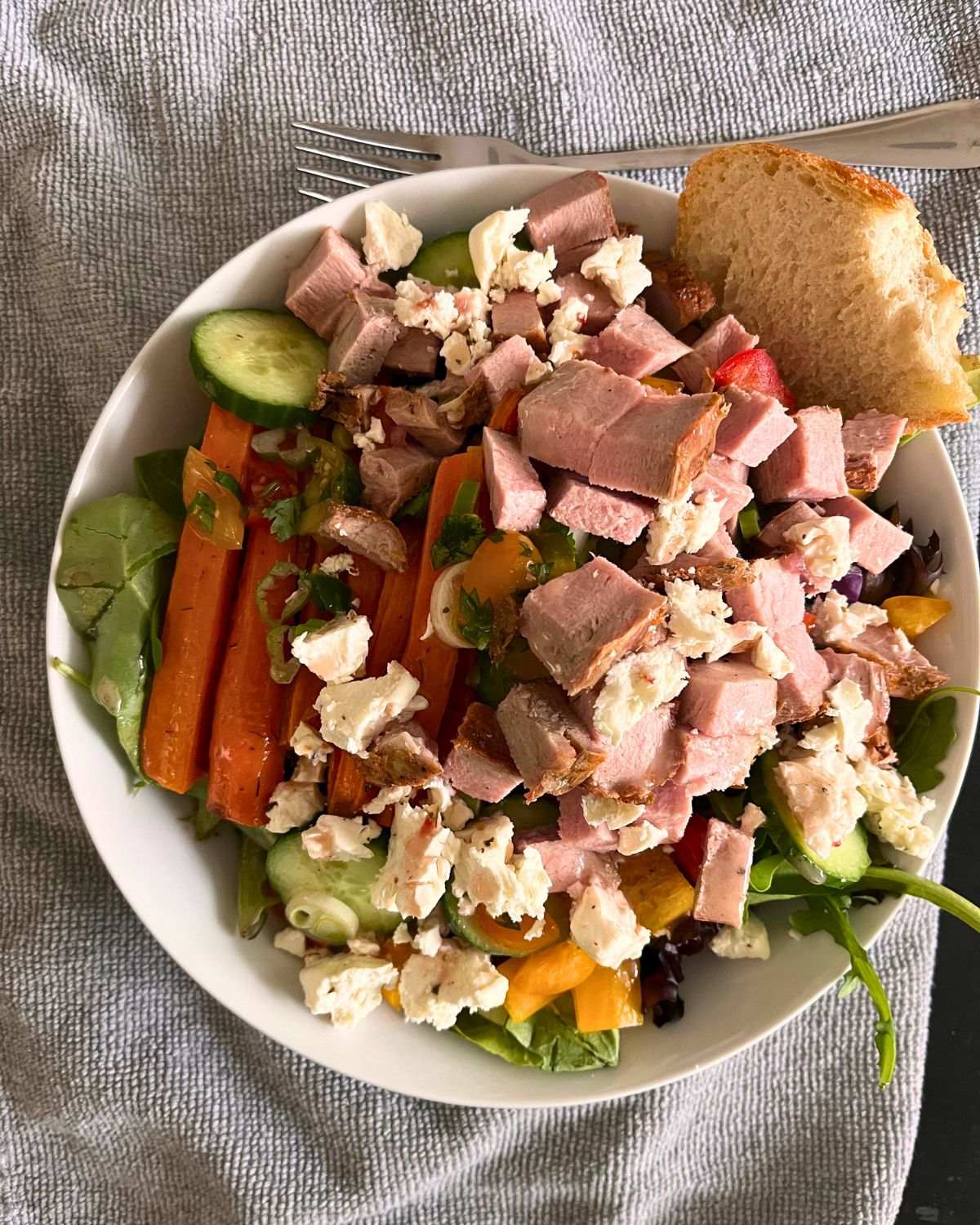 large lunch salad on gray cloth.